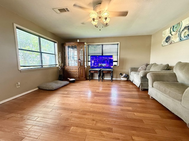 197 Osborne Dr, Bridge City, TX 77611 - living room featuring a ceiling fan, light wood finished floors, and baseboards