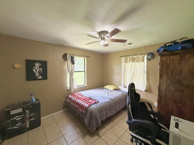 197 Osborne Dr, Bridge City, TX 77611 - bedroom with light tile patterned floors, ceiling fan, a textured ceiling, and baseboards
