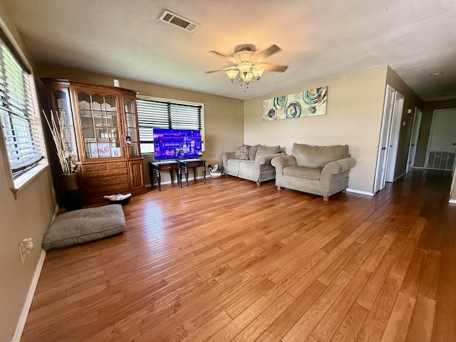 197 Osborne Dr, Bridge City, TX 77611 - living area featuring baseboards, wood finished floors, and ceiling fan