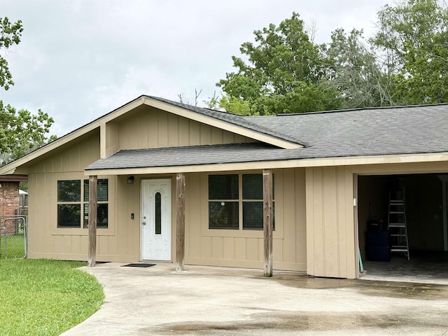 single story home featuring roof with shingles