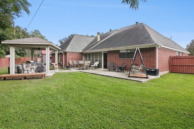 back of house with a patio, ceiling fan, and a lawn