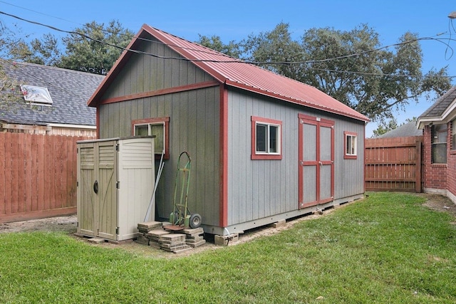 view of outbuilding featuring a lawn