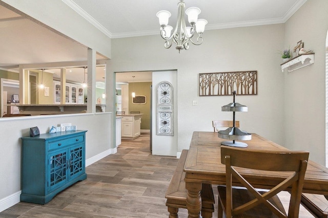 dining room featuring wood-type flooring, crown molding, and a chandelier