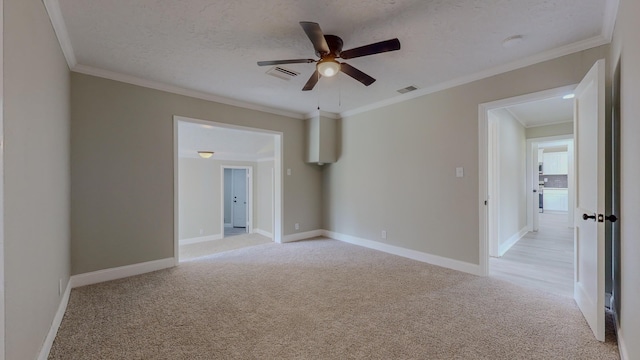 carpeted empty room featuring crown molding, ceiling fan, and a textured ceiling