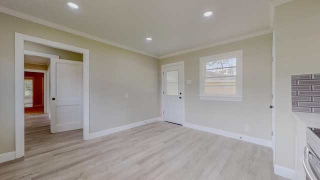 interior space featuring light hardwood / wood-style floors and ornamental molding