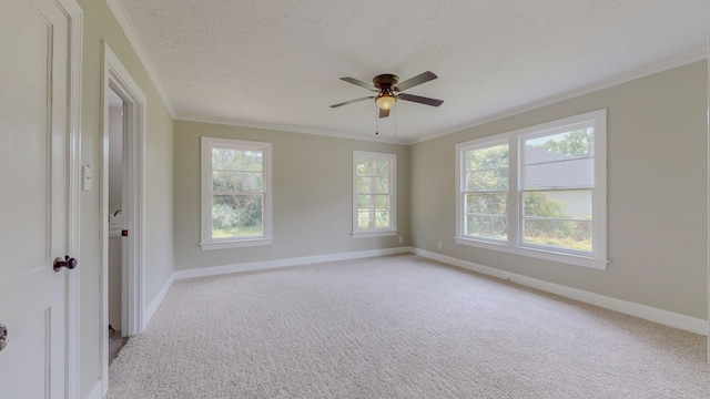 unfurnished room with ceiling fan, light colored carpet, ornamental molding, and a textured ceiling