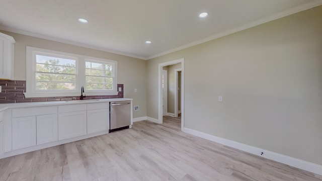 kitchen with white cabinets, sink, stainless steel dishwasher, ornamental molding, and light wood-type flooring