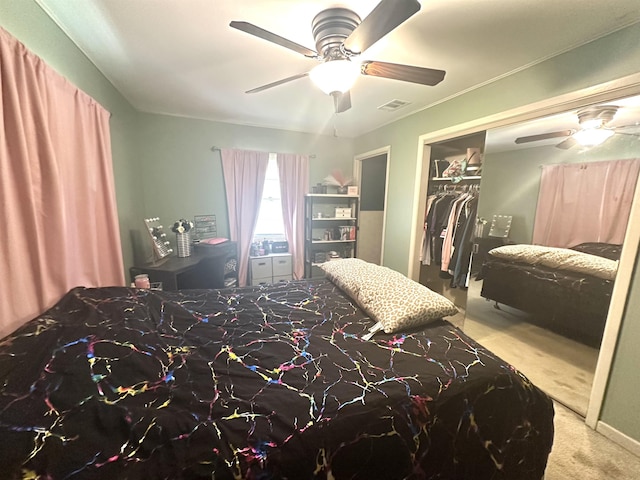 bedroom with ceiling fan, light colored carpet, and a closet