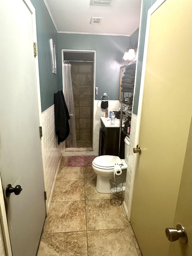 bathroom with toilet, vanity, and walk in shower