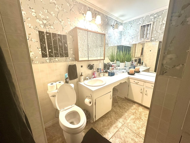 bathroom featuring vanity, crown molding, tile patterned flooring, toilet, and tile walls