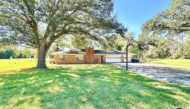 single story home featuring a garage and a front yard