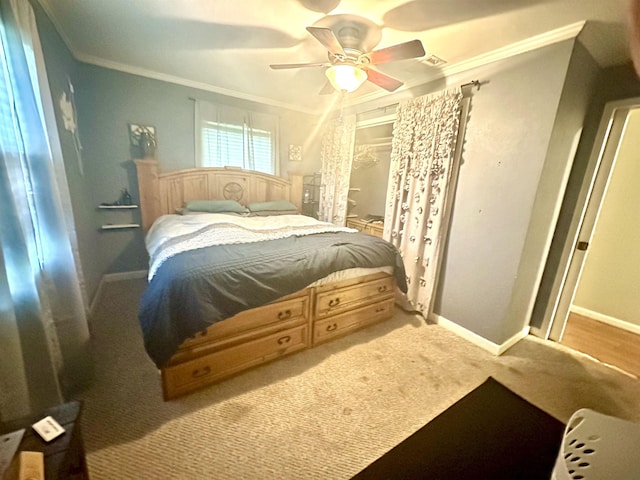 carpeted bedroom featuring ceiling fan and ornamental molding