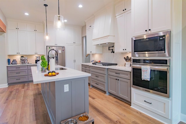 245 Balsam Bnd, Lumberton, TX 77657 - kitchen featuring stainless steel appliances, gray cabinetry, a sink, decorative backsplash, and recessed lighting