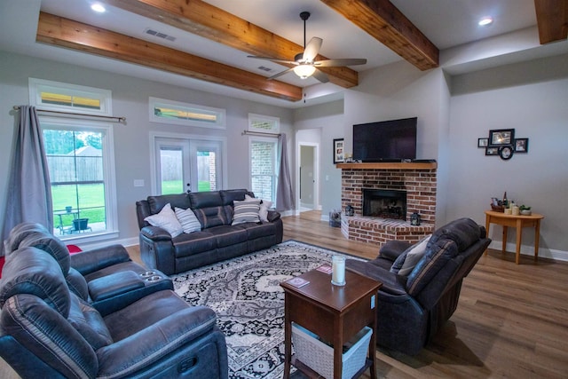 245 Balsam Bnd, Lumberton, TX 77657 - living area featuring ceiling fan, baseboards, wood finished floors, beam ceiling, and a brick fireplace