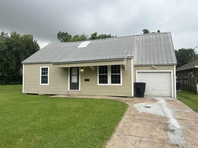 127 Hilldale Dr, Nederland, TX 77627 - view of front of home with concrete driveway, a garage, a front lawn, and metal roof
