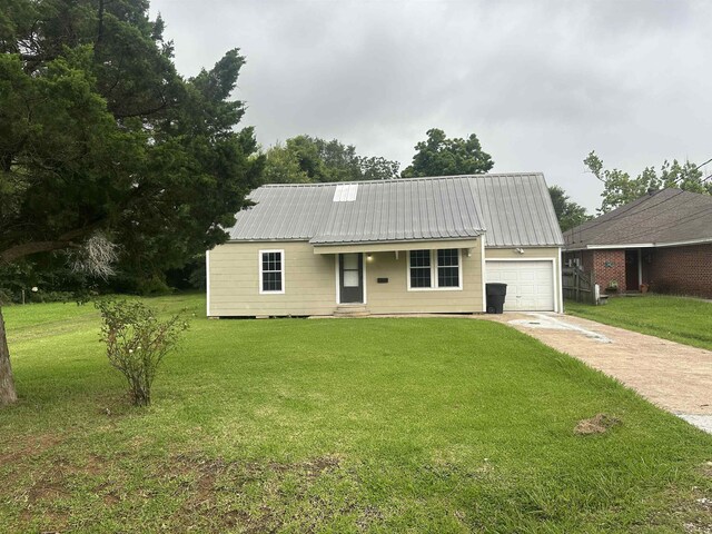 127 Hilldale Dr, Nederland, TX 77627 - view of front of home featuring an attached garage, driveway, a front lawn, and metal roof