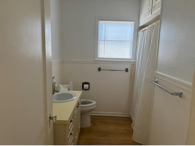 bathroom featuring hardwood / wood-style flooring, vanity, and toilet