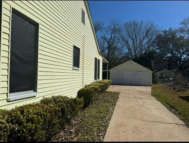 view of side of home with a garage and an outbuilding