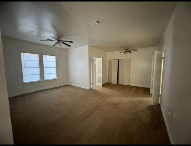 spare room featuring ceiling fan and carpet flooring