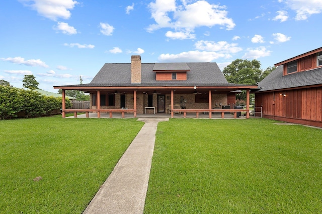 1911 Huntsman St, Orange, TX 77632 - rear view of property with a patio area, a chimney, a yard, and roof with shingles
