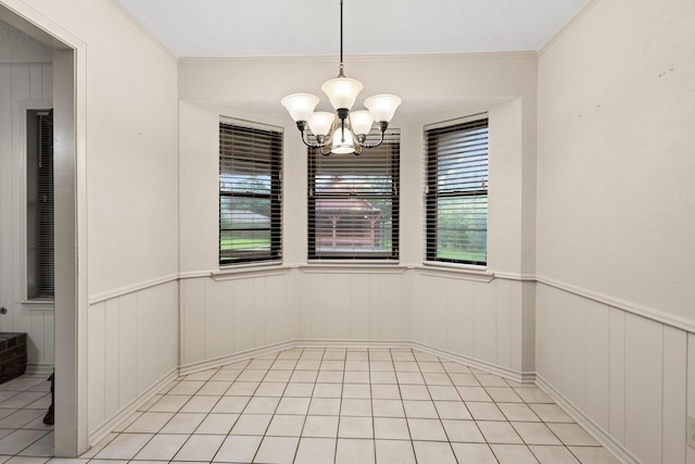 1911 Huntsman St, Orange, TX 77632 - unfurnished dining area featuring plenty of natural light, a chandelier, a wainscoted wall, light tile patterned flooring, and crown molding