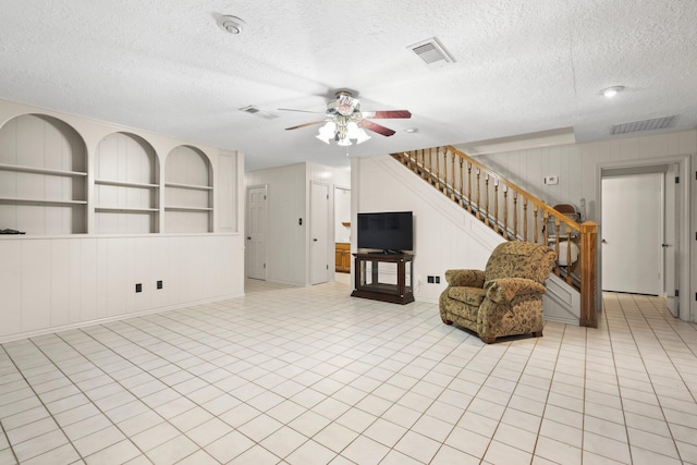 1911 Huntsman St, Orange, TX 77632 - living area with a ceiling fan, a textured ceiling, and stairway