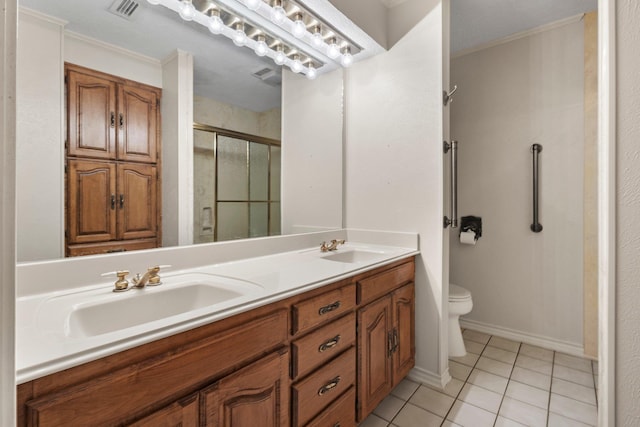 1911 Huntsman St, Orange, TX 77632 - bathroom with double vanity, a stall shower, tile patterned flooring, toilet, and crown molding