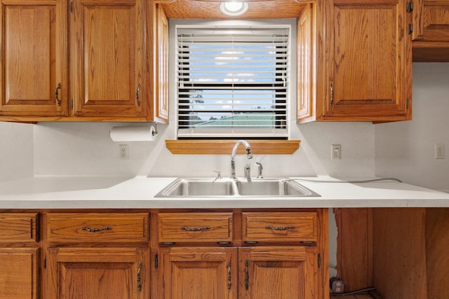 1911 Huntsman St, Orange, TX 77632 - kitchen with a sink, light countertops, and brown cabinetry
