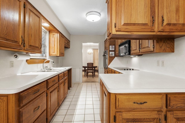 1911 Huntsman St, Orange, TX 77632 - kitchen with a sink, black appliances, brown cabinets, and light countertops