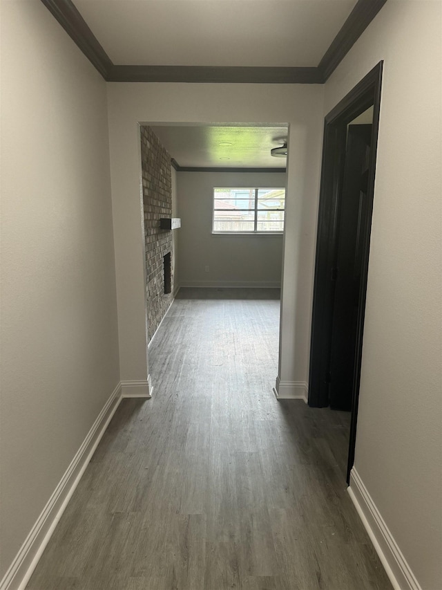 corridor featuring dark hardwood / wood-style flooring and ornamental molding