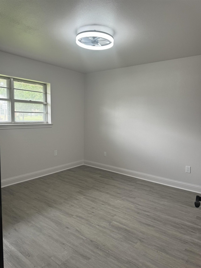 spare room with dark hardwood / wood-style floors