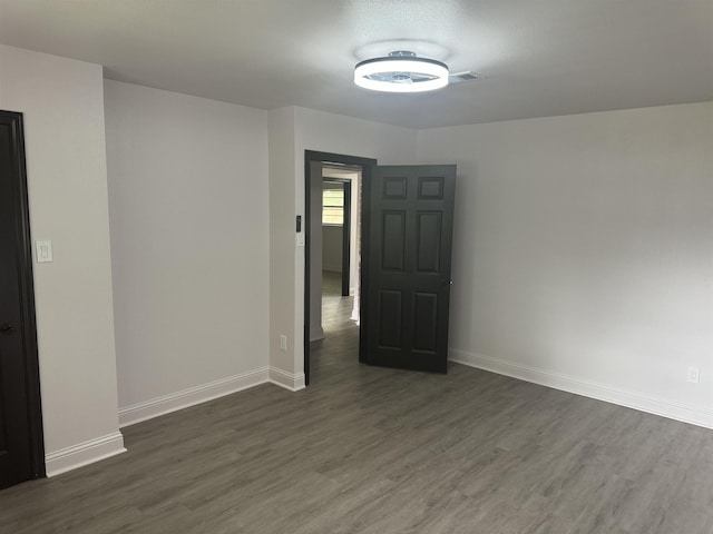 unfurnished room with dark hardwood / wood-style floors