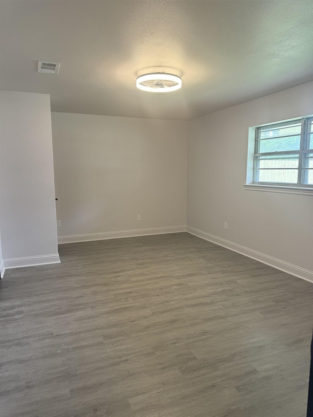 spare room featuring dark hardwood / wood-style flooring