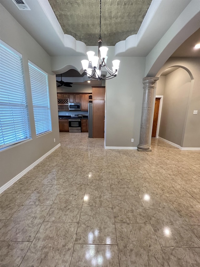 kitchen featuring hanging light fixtures, ceiling fan with notable chandelier, decorative columns, and appliances with stainless steel finishes