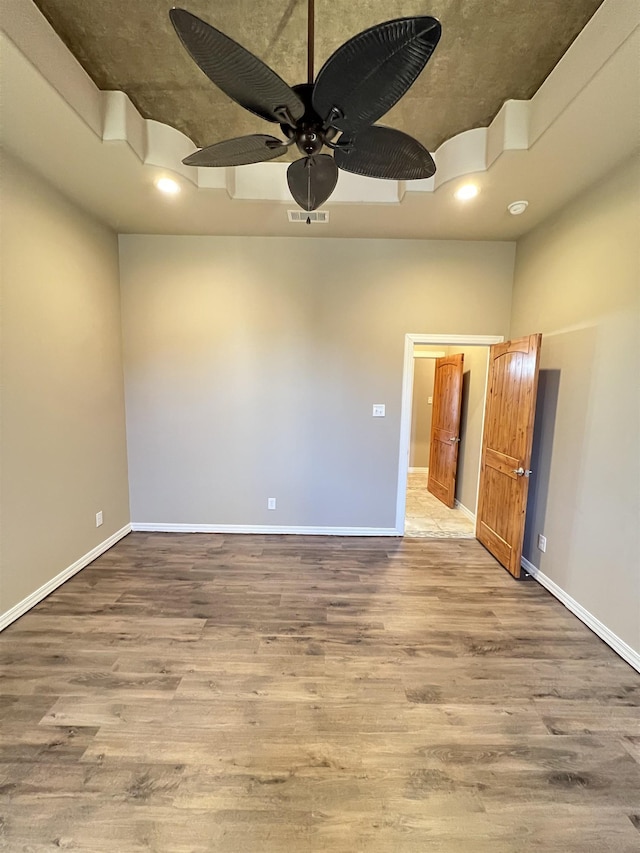 unfurnished room featuring hardwood / wood-style floors and ceiling fan