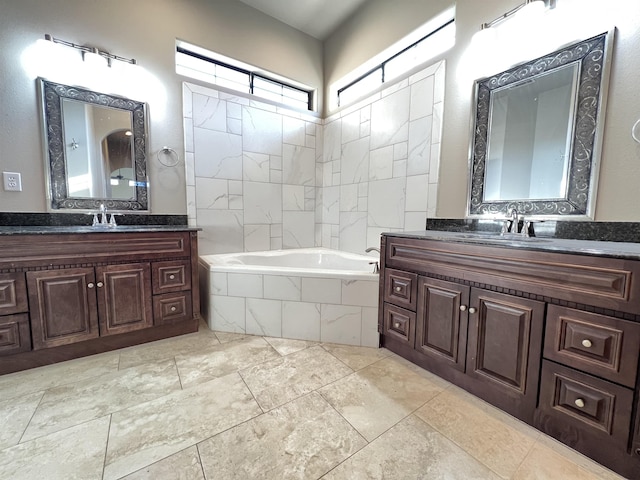 bathroom with vanity and tiled bath