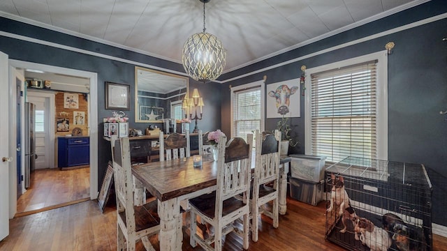 2635 Gladys Ave, Beaumont, TX 77701 - dining space with crown molding, an inviting chandelier, and light wood-style floors