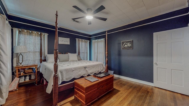 2635 Gladys Ave, Beaumont, TX 77701 - bedroom with ornamental molding, ceiling fan, wood-type flooring, baseboards, and visible vents