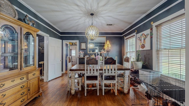 2635 Gladys Ave, Beaumont, TX 77701 - dining space featuring an inviting chandelier, visible vents, hardwood / wood-style flooring, and ornamental molding