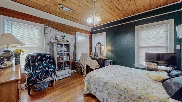 2635 Gladys Ave, Beaumont, TX 77701 - bedroom with visible vents, wood finished floors, multiple windows, and wood ceiling
