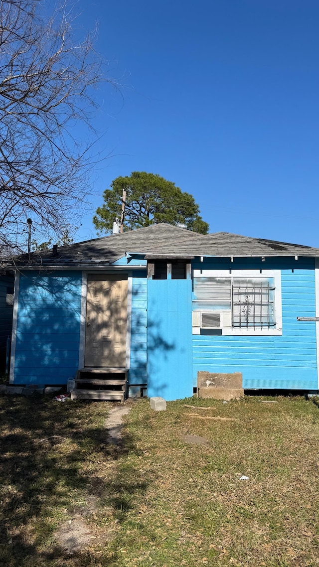 back of house with a lawn