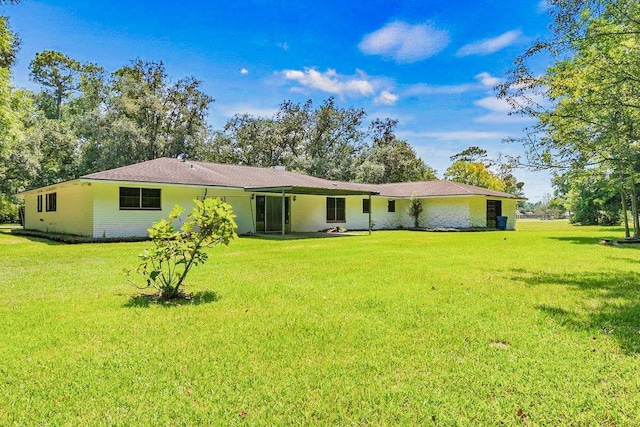 3640 Whippoorwill St, Orange, TX 77630 - rear view of house with a lawn