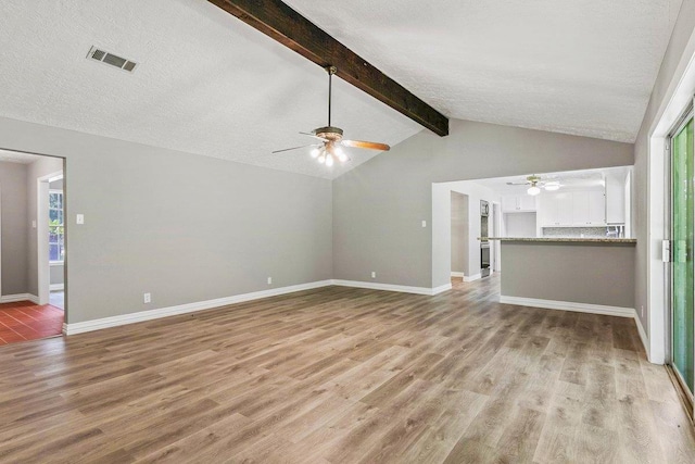3640 Whippoorwill St, Orange, TX 77630 - unfurnished living room featuring ceiling fan, light wood-type flooring, a textured ceiling, and healthy amount of natural light