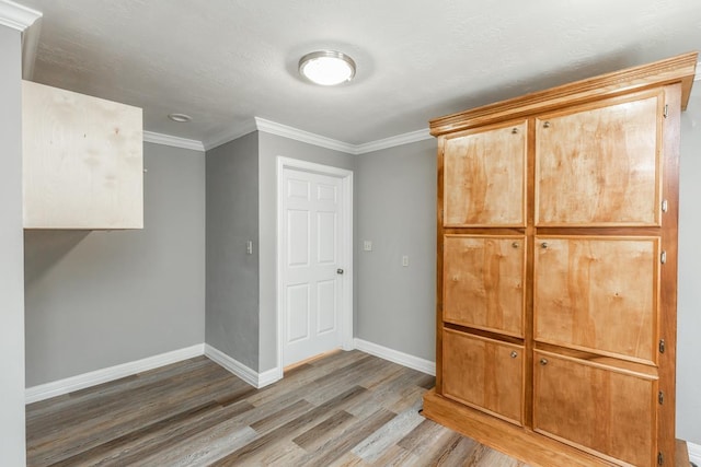 interior space featuring hardwood / wood-style flooring and ornamental molding