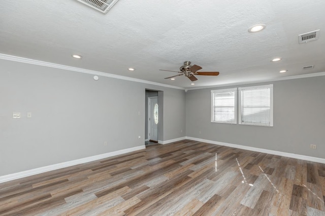 spare room featuring hardwood / wood-style floors, ceiling fan, crown molding, and a textured ceiling