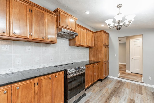 kitchen featuring pendant lighting, lofted ceiling, stainless steel range with electric cooktop, light hardwood / wood-style flooring, and a chandelier