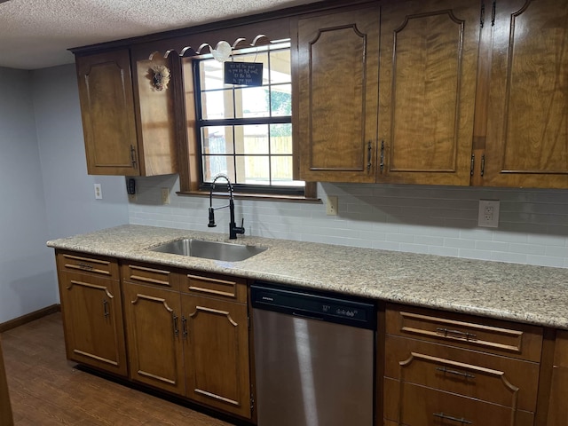 kitchen featuring sink, backsplash, dishwasher, and dark wood-type flooring