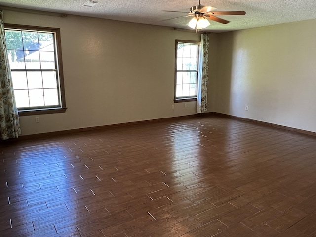 empty room featuring ceiling fan and a textured ceiling