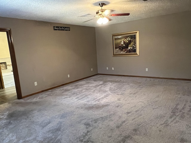 carpeted spare room featuring a textured ceiling and ceiling fan