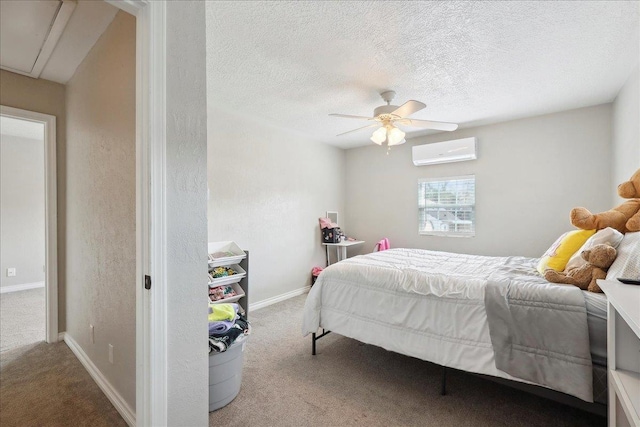 carpeted bedroom featuring ceiling fan, a textured ceiling, and an AC wall unit